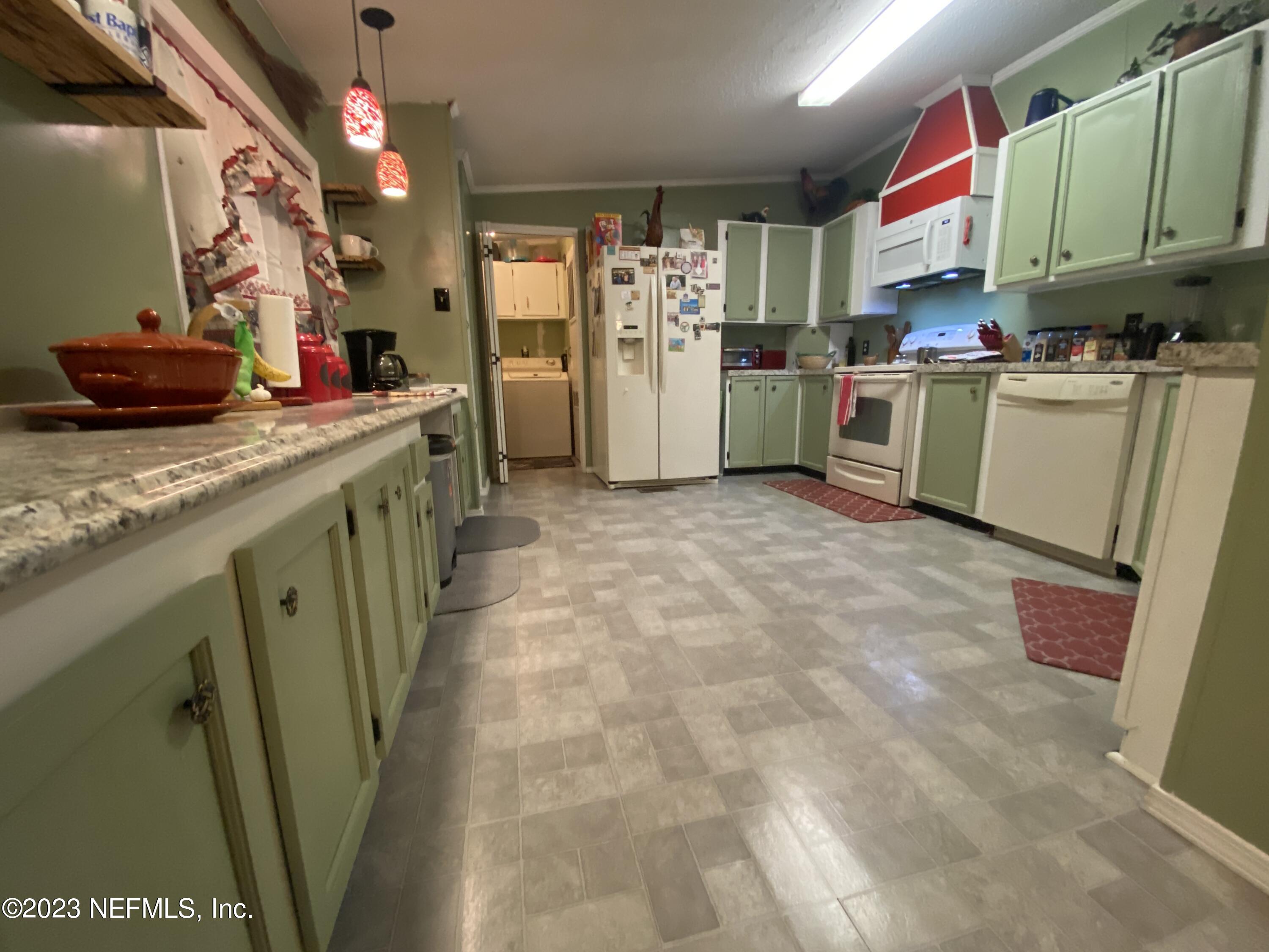 3966 Michaelwood Road Middleburg, FL 32068 - Photo 7 of 17 a kitchen with refrigerator and cabinets