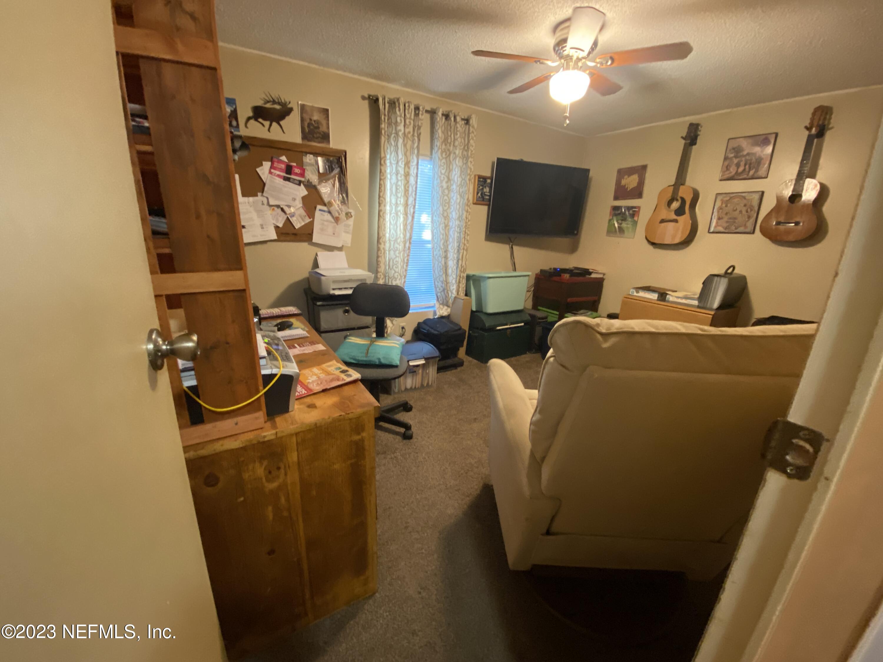 3966 Michaelwood Road Middleburg, FL 32068 - Photo 10 of 17 a living room with furniture and a flat screen tv