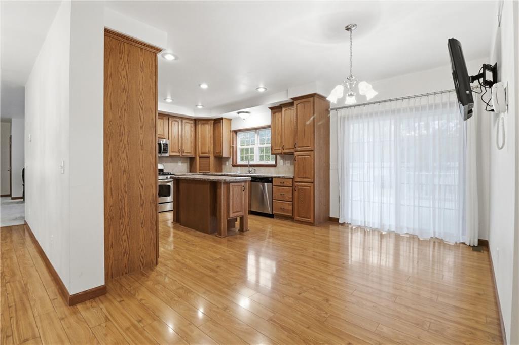 197 Smugglers Road Du Bois, PA 15801 - Photo 19 of 41 a open kitchen with stainless steel appliances granite countertop a refrigerator a stove and a wooden floor