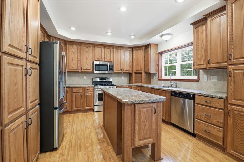 197 Smugglers Road Du Bois, PA 15801 - Photo 21 of 41 a kitchen with stainless steel appliances granite countertop a stove a sink dishwasher a refrigerator and a microwave oven with wooden floor
