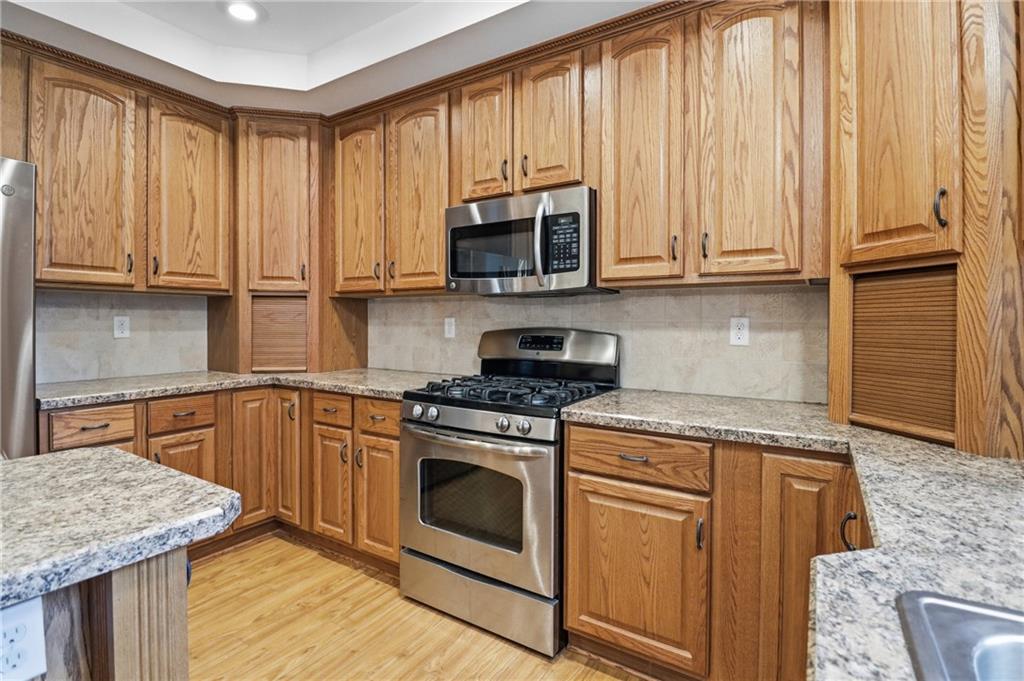 197 Smugglers Road Du Bois, PA 15801 - Photo 24 of 41 a kitchen with stainless steel appliances granite countertop a stove a sink and a microwave
