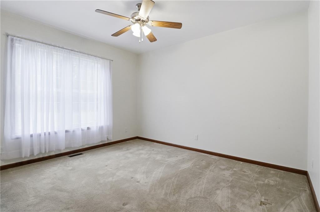 197 Smugglers Road Du Bois, PA 15801 - Photo 32 of 41 an empty room with a chandelier fan and windows