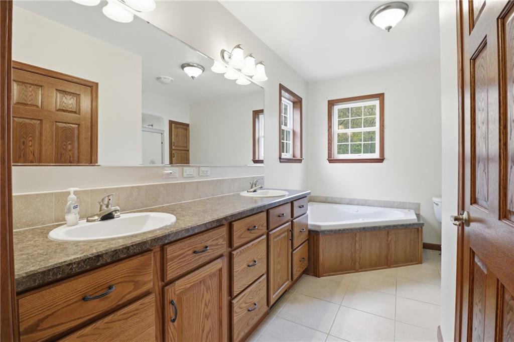 197 Smugglers Road Du Bois, PA 15801 - Photo 35 of 41 a spacious bathroom with a granite countertop sink a toilet a mirror and a bathtub