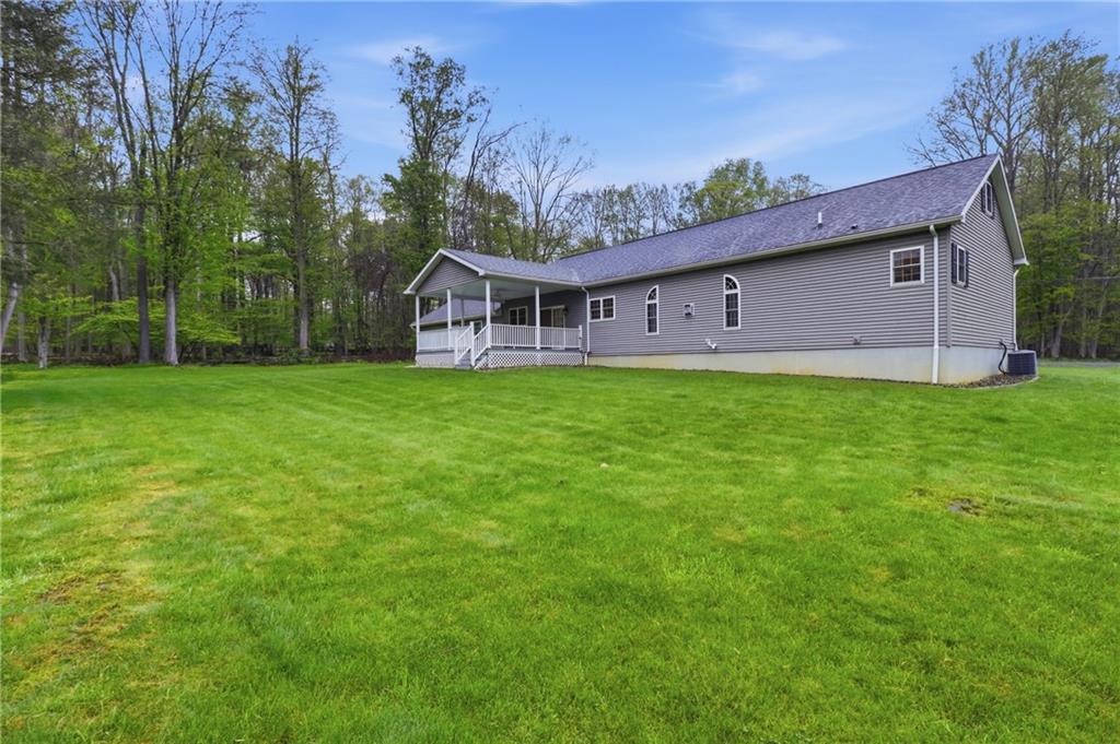 197 Smugglers Road Du Bois, PA 15801 - Photo 7 of 41 a house that is sitting in the grass with large trees and plants