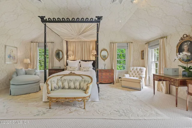 a bedroom with a bed and a couch