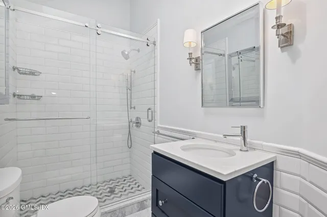 a bathroom with a sink toilet and shower