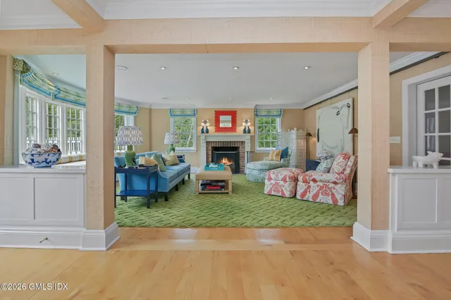 a living room with fireplace furniture and a fireplace