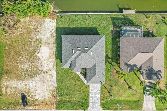 an aerial view of a house with a yard