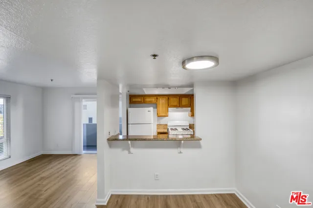 a view of kitchen with a sink wooden floor and a window