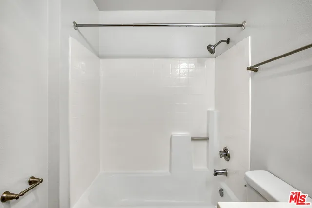 a bathroom with a shower and a tub