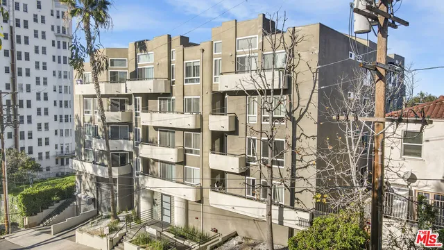 a aerial view of multi story residential apartment building with yard