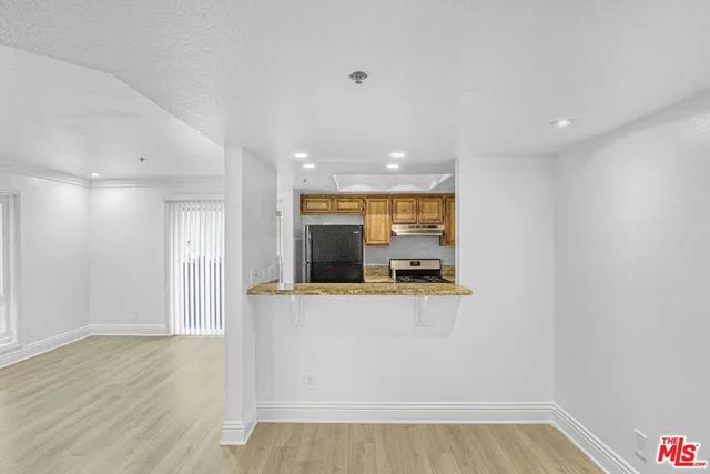 a view of a room with wooden floor and cabinet