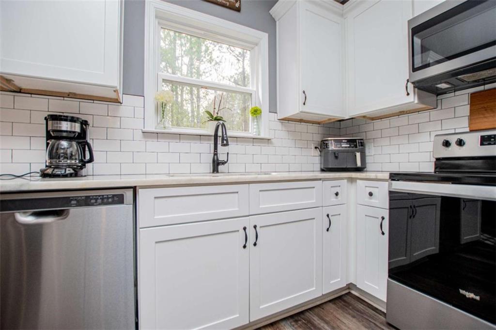 133 Pebblebrook Way Temple, GA 30179 - Photo 23 of 65 a kitchen with appliances cabinets and a sink