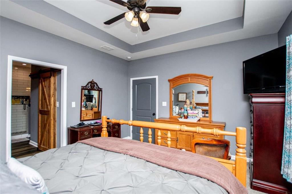 133 Pebblebrook Way Temple, GA 30179 - Photo 29 of 65 a bedroom with a bed and a flat tv screen on dresser