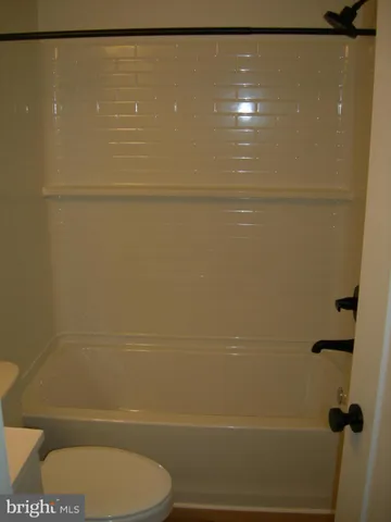 a bathroom with a shower and a toilet
