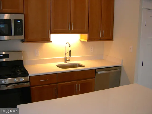 a kitchen with a sink and cabinets