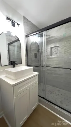 a bathroom with a double vanity sink and mirror
