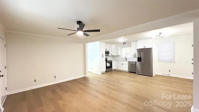 a view of a kitchen with a sink and a refrigerator