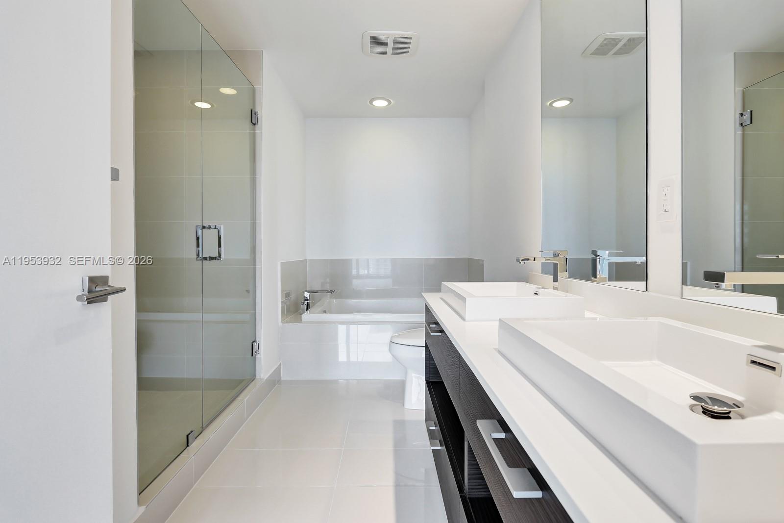 45 Southwest 9th Street, Unit 1806 Miami, FL 33130 - Photo 15 of 61 a bathroom with a tub sink and mirror