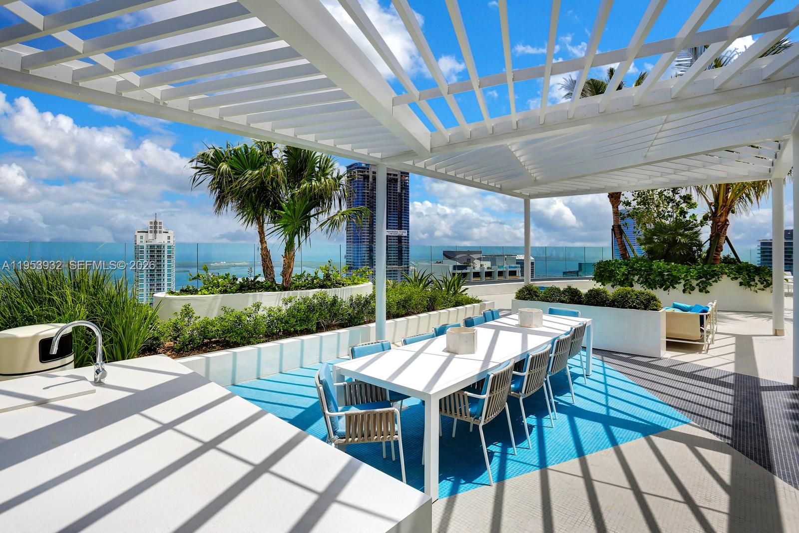 45 Southwest 9th Street, Unit 1806 Miami, FL 33130 - Photo 26 of 61 a view of a patio with a dining table and chairs with a couches near a patio