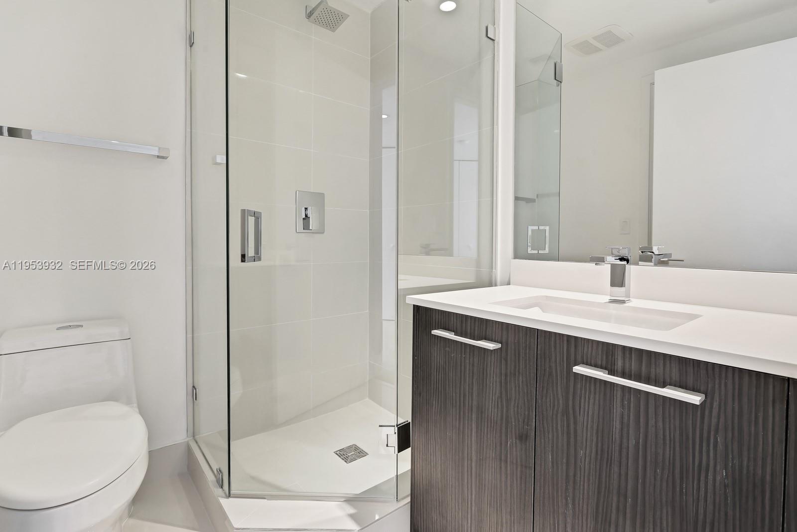 45 Southwest 9th Street, Unit 1806 Miami, FL 33130 - Photo 4 of 61 a bathroom with a sink a toilet and shower