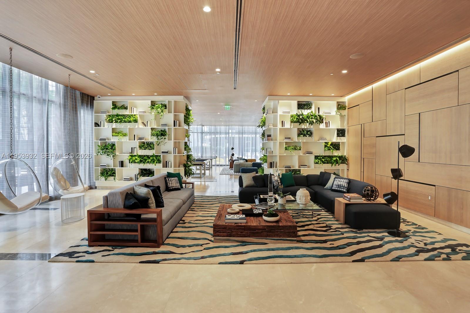 45 Southwest 9th Street, Unit 1806 Miami, FL 33130 - Photo 48 of 61 a view of a lobby with furniture and floor to ceiling window