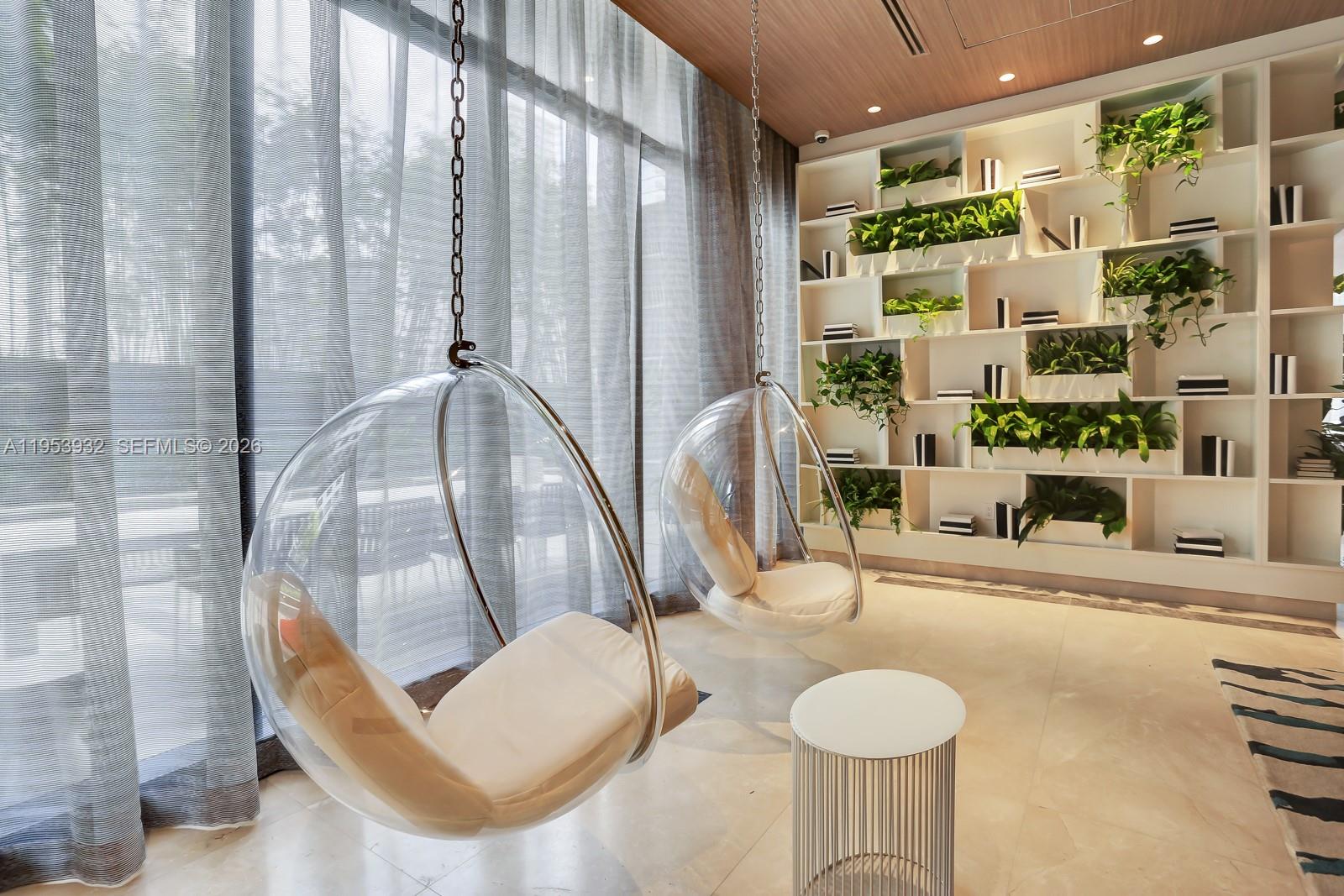 45 Southwest 9th Street, Unit 1806 Miami, FL 33130 - Photo 49 of 61 a living room with furniture and a floor to ceiling window