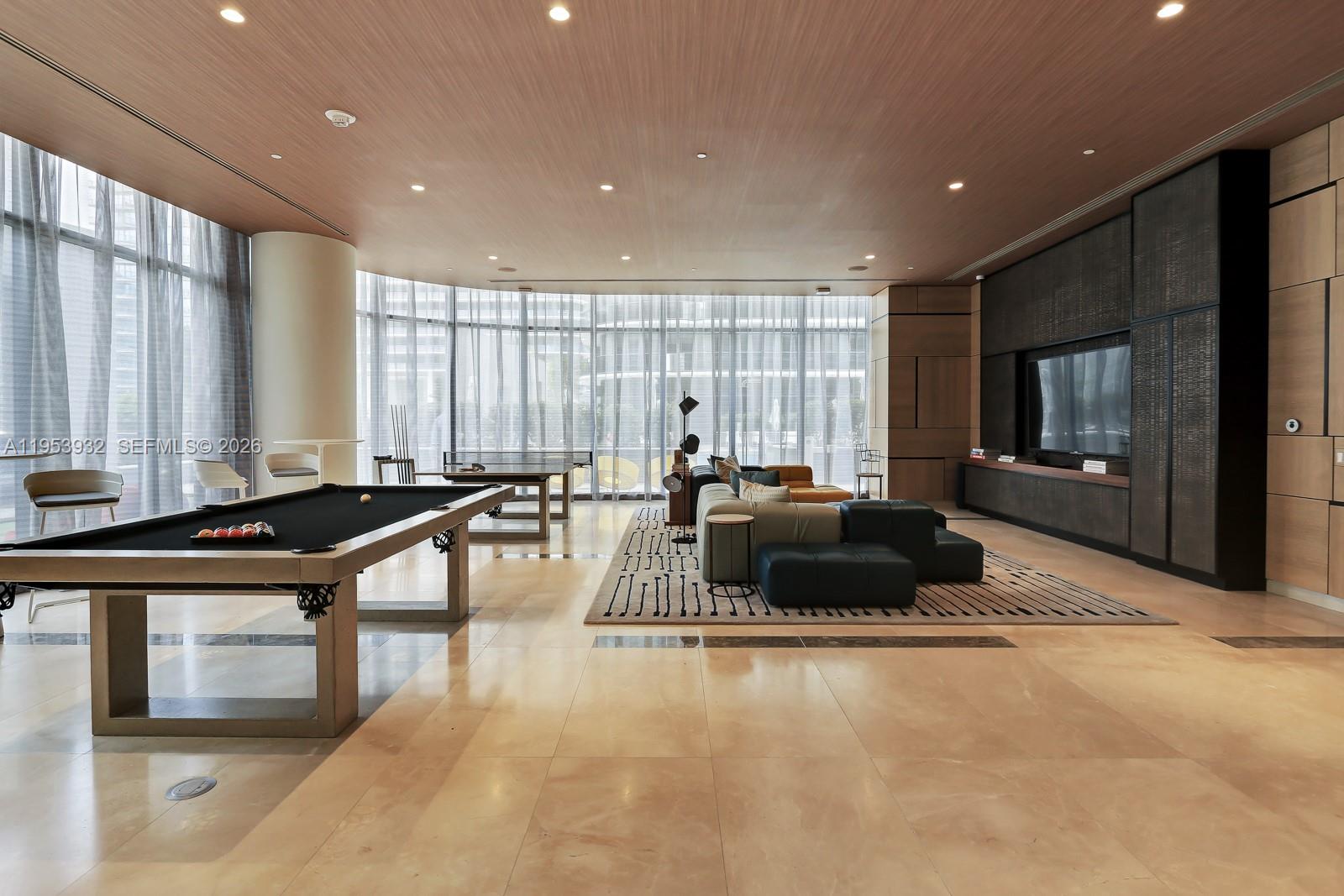 45 Southwest 9th Street, Unit 1806 Miami, FL 33130 - Photo 52 of 61 a living room with furniture and a flat screen tv