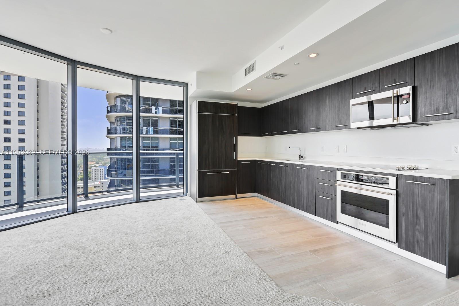 45 Southwest 9th Street, Unit 1806 Miami, FL 33130 - Photo 10 of 61 a view of a kitchen with furniture and a kitchen