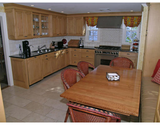 98 Richmond Road Belmont, MA 02478 - Photo 5 of 20 a kitchen with cabinets a stove and a refrigerator