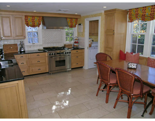 98 Richmond Road Belmont, MA 02478 - Photo 7 of 20 a kitchen with stainless steel appliances a stove a table and chairs in it