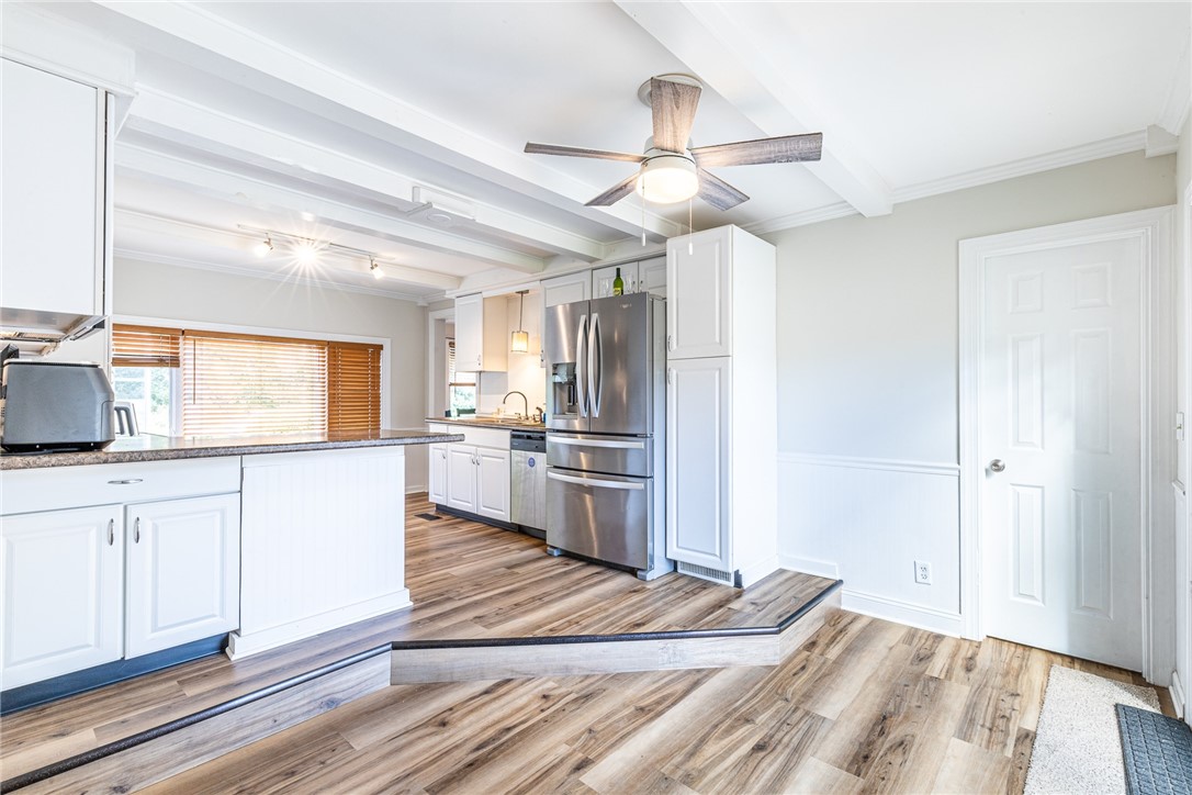 6432 Lakeside Road Ontario, NY 14519 - Photo 17 of 35 Beamed ceilings and classic wood floors elevate this beautifully updated culinary space.