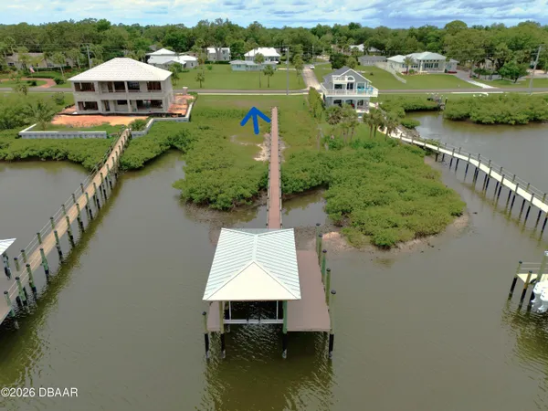an aerial view of a house with a lake view