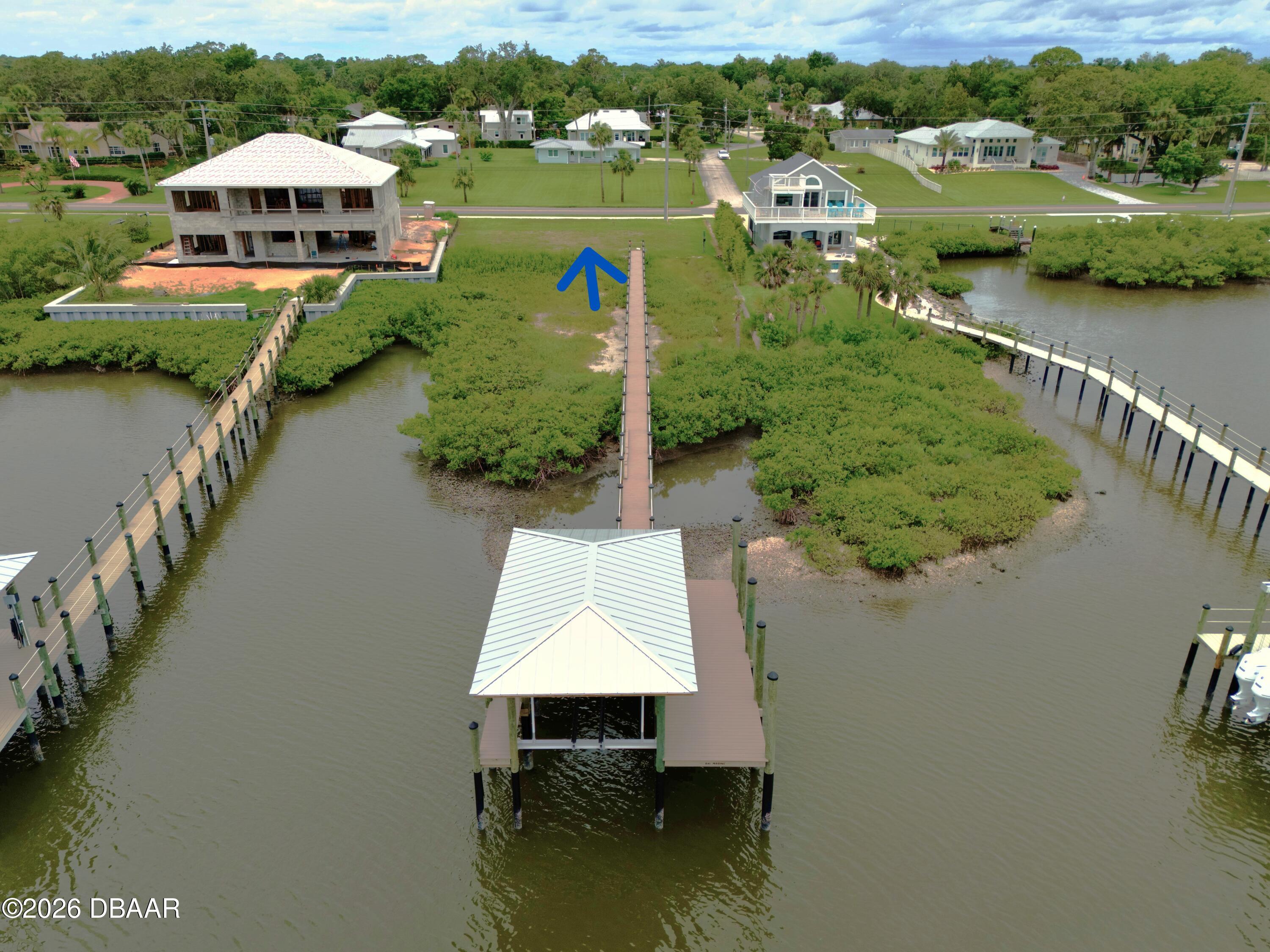 an aerial view of a house with a lake view