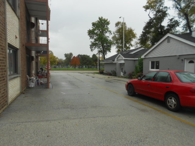 5724 West 111th Street, Unit 3B Chicago Ridge, IL 60415 - Photo 13 of 14 a front view of a house with cars parked