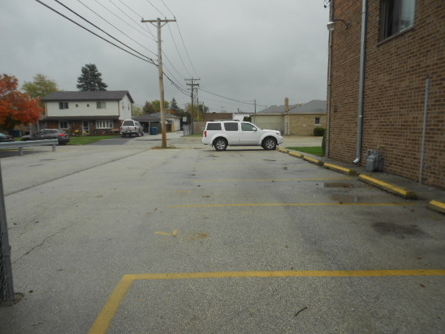 5724 West 111th Street, Unit 3B Chicago Ridge, IL 60415 - Photo 14 of 14 a car parked on the side of the road