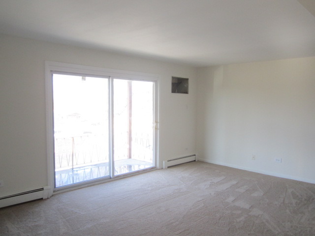 5724 West 111th Street, Unit 3B Chicago Ridge, IL 60415 - Photo 2 of 14 an empty room with windows