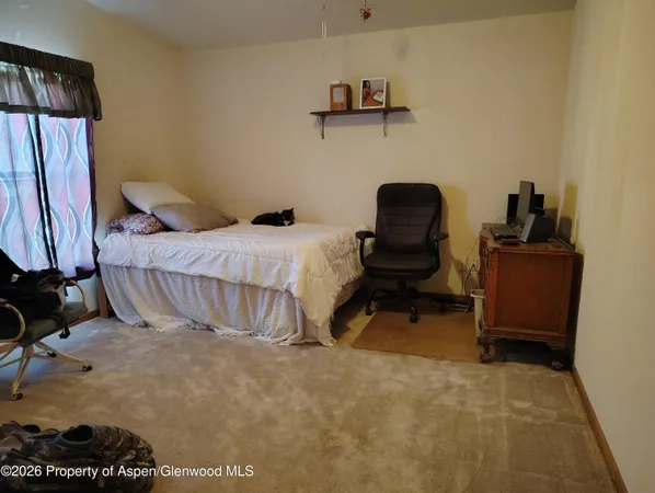 a bedroom with a bed and a chair