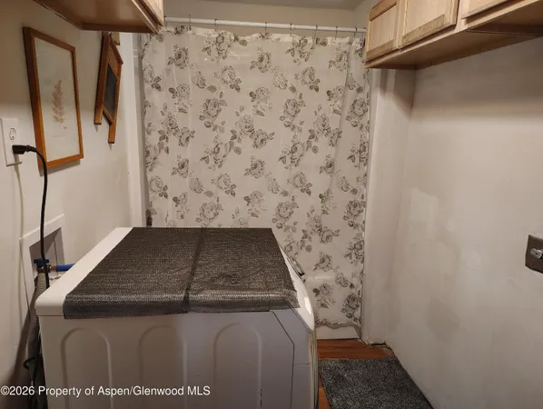 a bedroom with a bed and a lamp on dresser