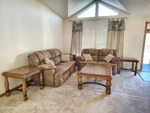 a living room with furniture and a rug