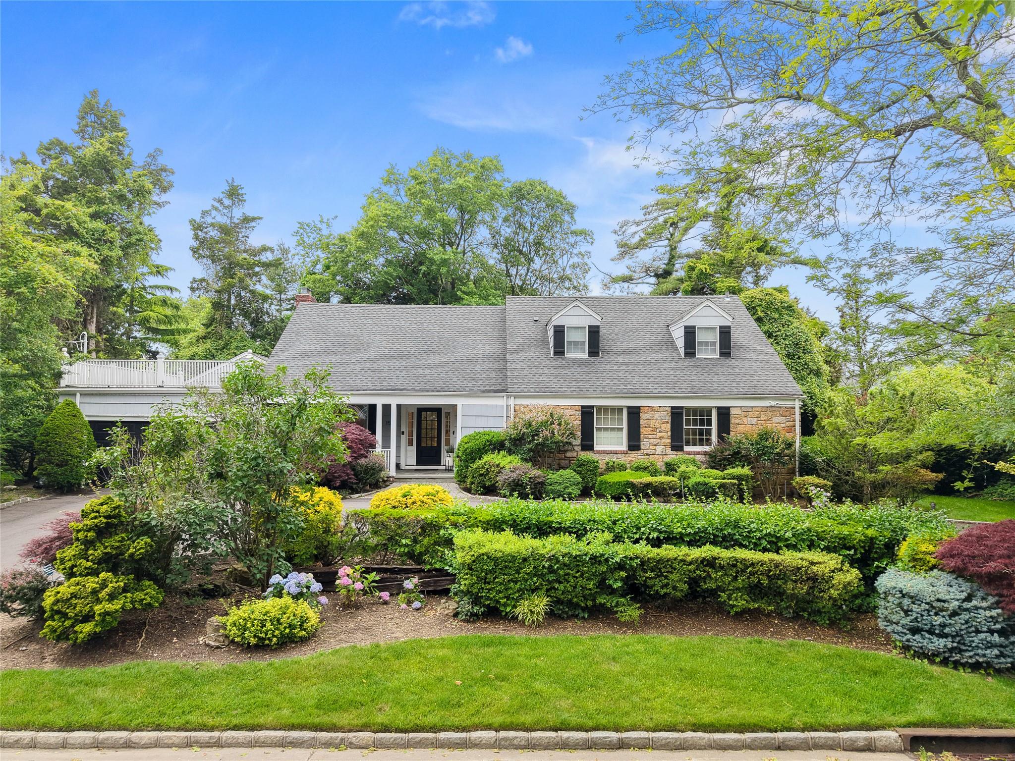 156 Lefferts Road Woodmere, NY 11598 - Photo 1 of 1 Expanded ranch featuring cedar wood and stone siding