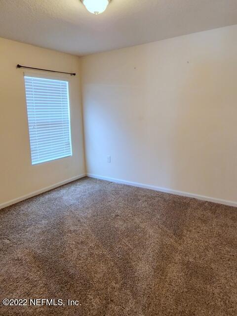 4295 Packer Meadow Way Middleburg, FL 32068 - Photo 22 of 26 an empty room with a window