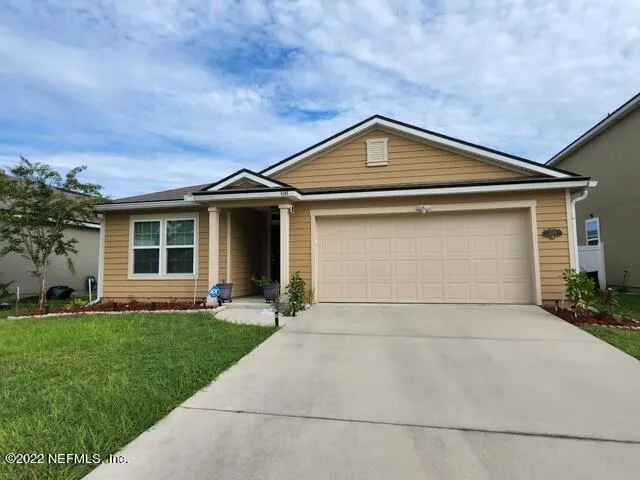 a front view of a house with a yard and garage