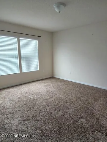 an empty room with a empty space and windows