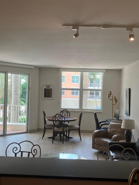802 West Windward Way, Unit 204 Lantana, FL 33462 - Photo 13 of 29 a living room with furniture and large windows