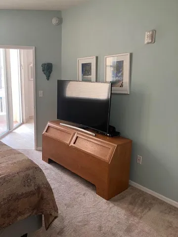 a living room with a bed furniture and mirror