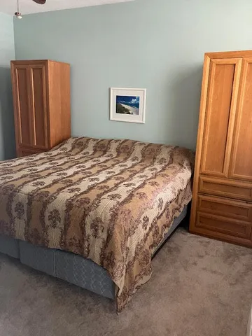 a bed sitting in a bedroom next to a window