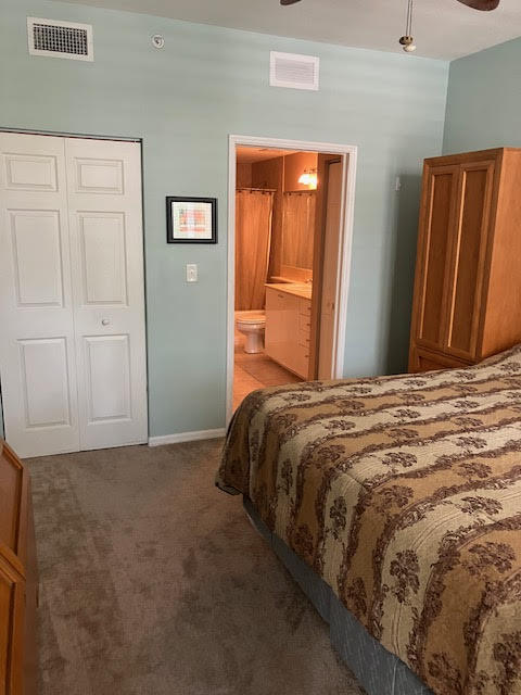 802 West Windward Way, Unit 204 Lantana, FL 33462 - Photo 24 of 29 a bedroom with a bed and wooden floor