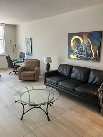 a living room with furniture and a rug