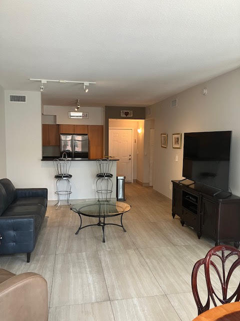 802 West Windward Way, Unit 204 Lantana, FL 33462 - Photo 7 of 29 a living room with furniture and a flat screen tv